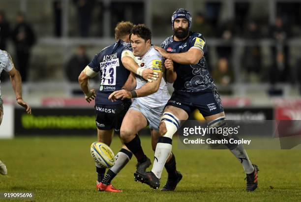 Brad Barritt of Saracens is tackled by Will Addison and Josh Strauss of Sale during the Aviva Premiership match between Sale Sharks and Saracens at...