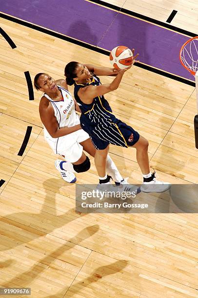 Tammy Sutton-Brown of the Indiana Fever shoots a layup against Le'coe Willingham of the Phoenix Mercury in Game Five of the WNBA Finals at U.S....