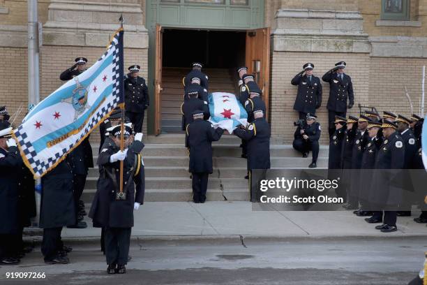 Draped with a city of Chicago plag, the remains of Police Commander Paul Bauer arrive at the Nativity of Our Lord church in the Bridgeport...