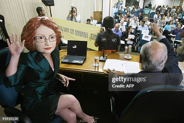 Greenpeace activist impersonating Brazil's Chief of Staff Dilma Russeff takes part in a protest against the authorization to grow transgenic rice...