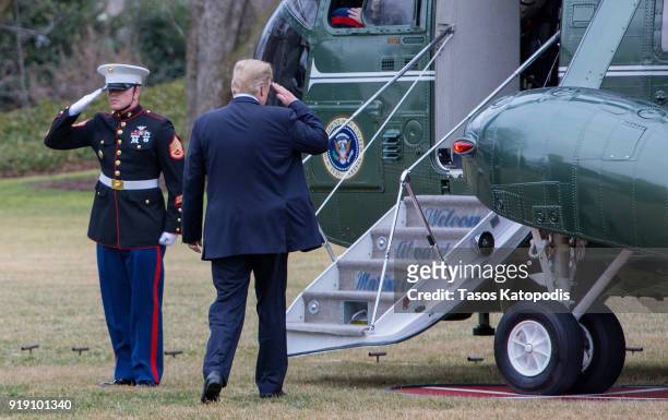 President Donald Trump walks from the Oval Office to the Marine One helicopter as they depart from the South Lawn of the White House on February 16,...