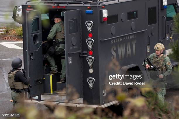 Members of a SWAT team work in a parking lot after a threat of an active shooter shut down campus at Highline College on February 16, 2018 in Des...