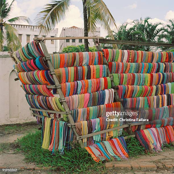 fabric swatches on wooden stand in stone town , zanzibar , tanzania , africa - stone town imagens e fotografias de stock