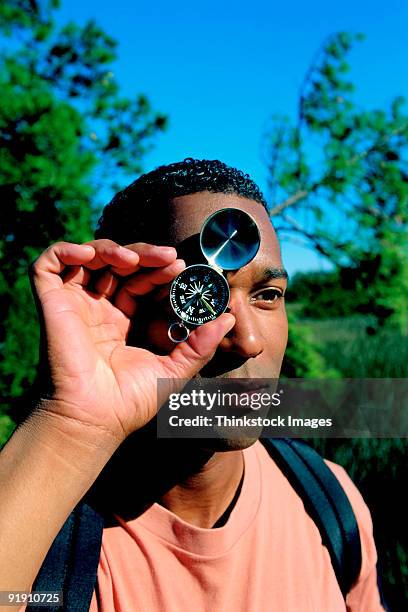 Guy Using A Compass 48 Black Person Holding Compass Stock Photos, High-Res Pictures, and ...