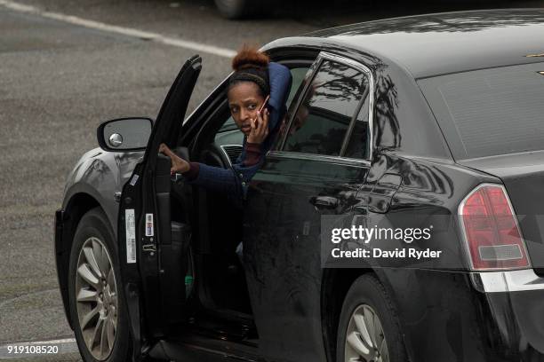 Student speaks on the phone in a campus parking lot after a threat of an active shooter shut down campus at Highline College on February 16, 2018 in...