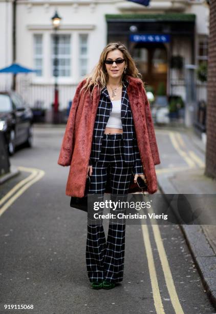 Chelsea Leyland wearing plaid flared pants, plaid jacket, cropped top seen outside Mulberry during London Fashion Week February 2018 on February 16,...