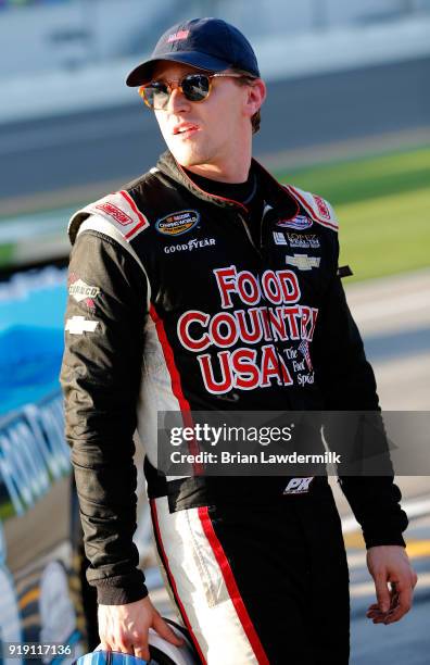 Parker Kligerman, driver of the Food Country USA/Lopez Wealth Mgmt. Chevrolet, stands by his truck during qualifying for the NASCAR Camping World...