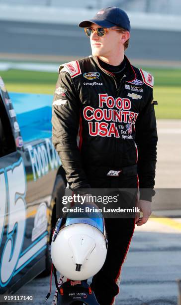 Parker Kligerman, driver of the Food Country USA/Lopez Wealth Mgmt. Chevrolet, stands by his truck during qualifying for the NASCAR Camping World...