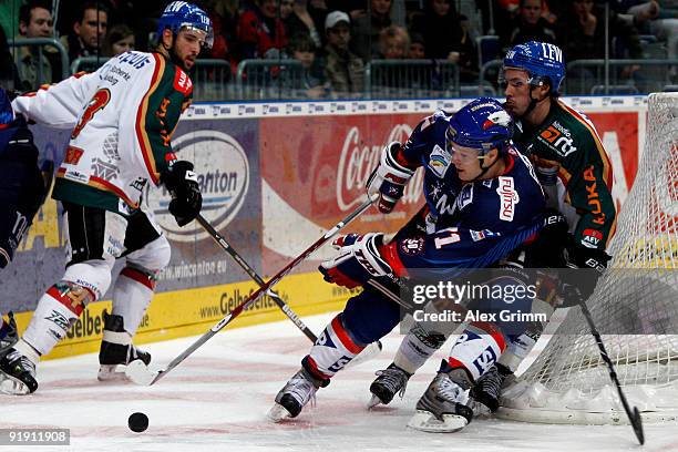 Justin Papineau of Mannheim is challenged by Darin Olver of Augsburg during the DEL match between Adler Mannheim and Augsburger Panther at the SAP...