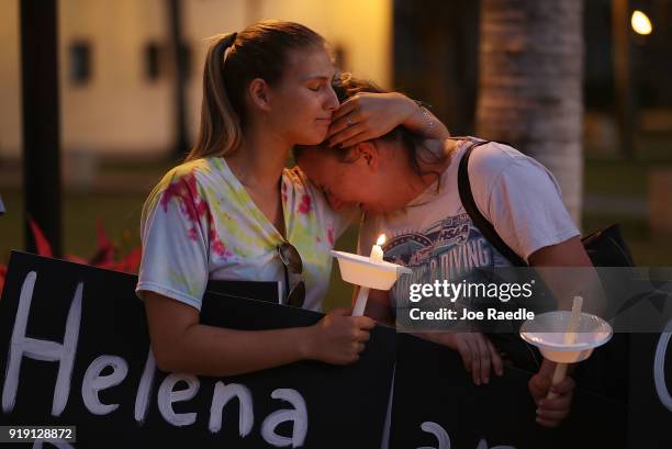Tori Stetzer and Taylor Miller become emotional as they attend a candle light vigil at Florida Atlantic University for the 17 people killed during a...