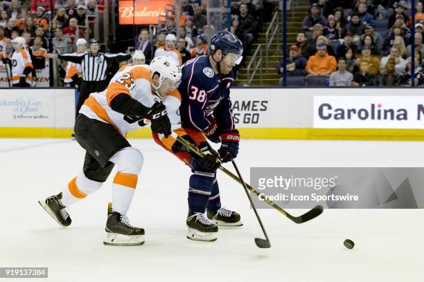 Philadelphia Flyers defenseman Brandon Manning and Columbus Blue Jackets center Boone Jenner battle for the puck in the first period of a game...
