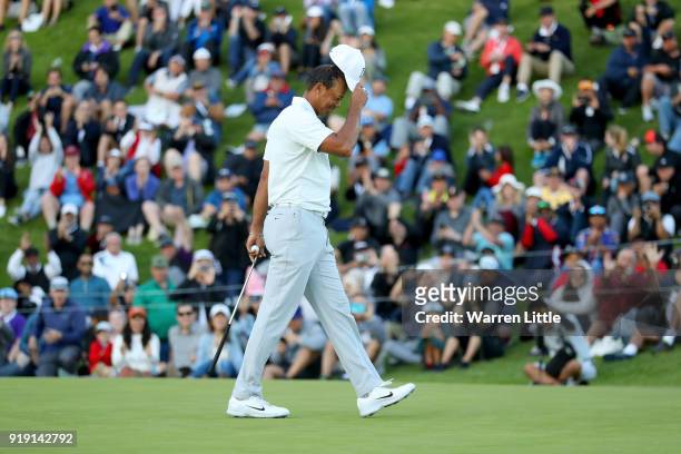 Tiger Woods acknowledges fans after finishing his round on the 18th green during the second round of the Genesis Open at Riviera Country Club on...