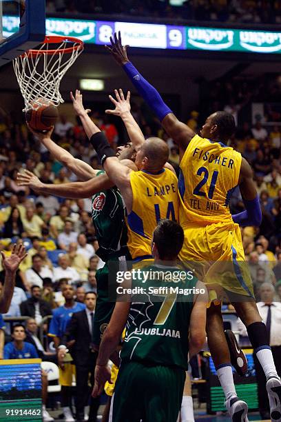 Edin Bavcic, #9 of Union Olimpija competes with D�or Fischer, #21 of Maccabi Electra & Maciej Lampe, #14 of Maccabi Electra in action during the...