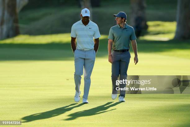 Tiger Woods and Rory McIlroy of Northern Ireland walk across the 17th hole during the second round of the Genesis Open at Riviera Country Club on...