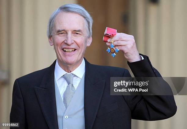 Organist Simon Preston with the CBE he received from Britain's Queen Elizabeth II during an investiture ceremony at Buckingham Palace on October 15...