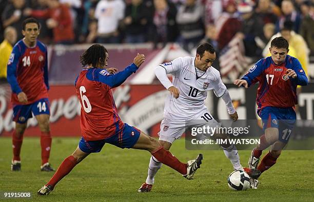 Landon Donovan of the US vies for the ball with Pablo Herrera and Michael Barrantes of Costa Rica during US v Costa Rica World Cup Qualifing match in...