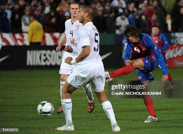 Costa Rican forward Bryan Ruiz shoots past Oguchi Onyewu and Michael Bradley during a 2010 World Cup qualifier against Costa Rica at RFK Stadium in...