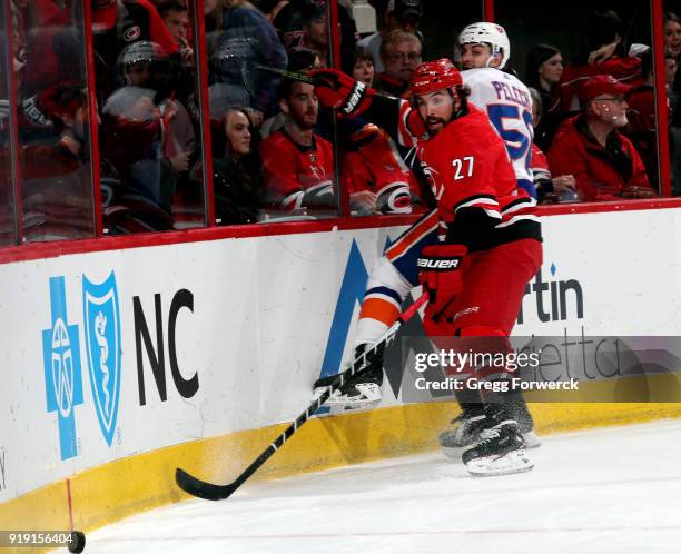 Justin Faulk of the Carolina Hurricanes knocks Adam Pelech of the New York Islanders off the puck during an NHL game on February 16, 2018 at PNC...