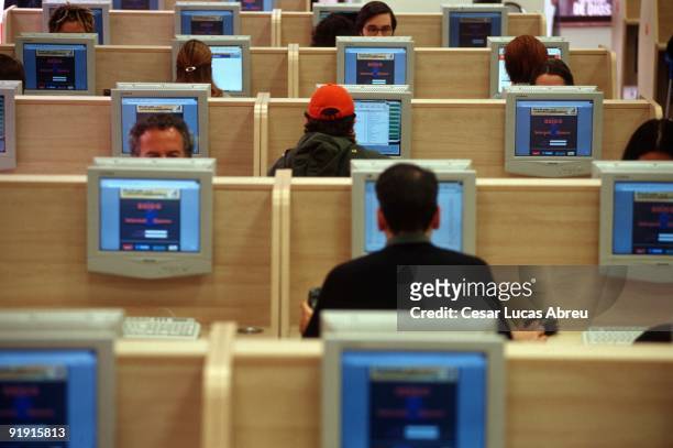 Cybernauts in front of computers in cibercafé BBIGG.