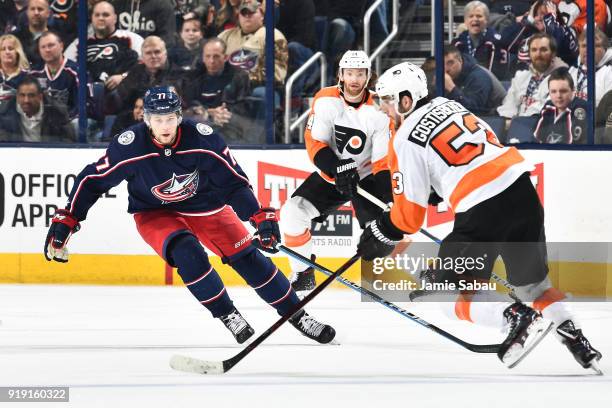 Josh Anderson of the Columbus Blue Jackets defends Shayne Gostisbehere of the Philadelphia Flyers as he skates with the puck during the third period...