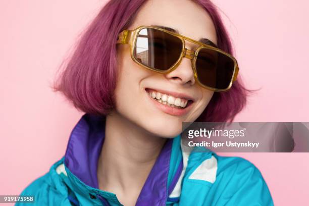 young woman with pink hair laughing - funky hair studio shot stock pictures, royalty-free photos & images