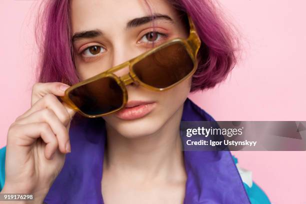 pink hair manga style girl holding sunglasses - purple hair stockfoto's en -beelden