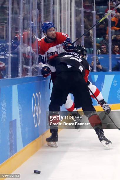 Eric O'Dell of Canada skates against Tomas Kundratek of the Czech Republic during the Men's Ice Hockey Preliminary Round Group A game on day eight of...