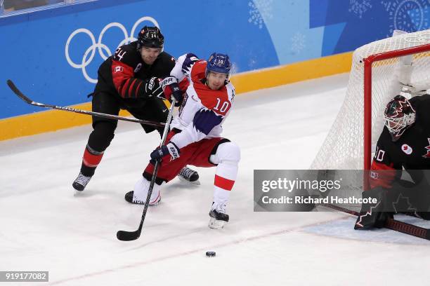 Roman Cervenka of the Czech Republic skates against Stefan Elliott of Canada during the Men's Ice Hockey Preliminary Round Group A game on day eight...