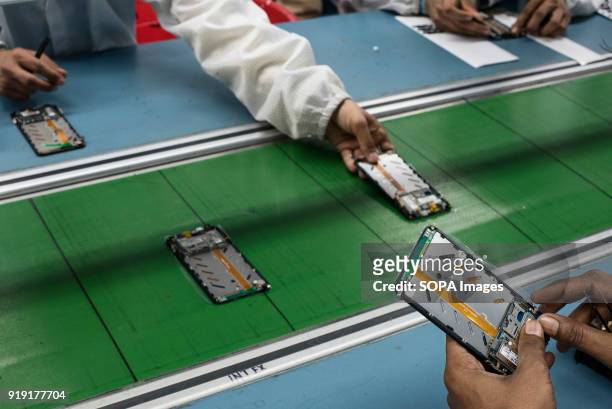 Workers assemble smartphones on the production line inside the Intex Technologies brand plant in Noida. Intex Technologies is a Smartphone...
