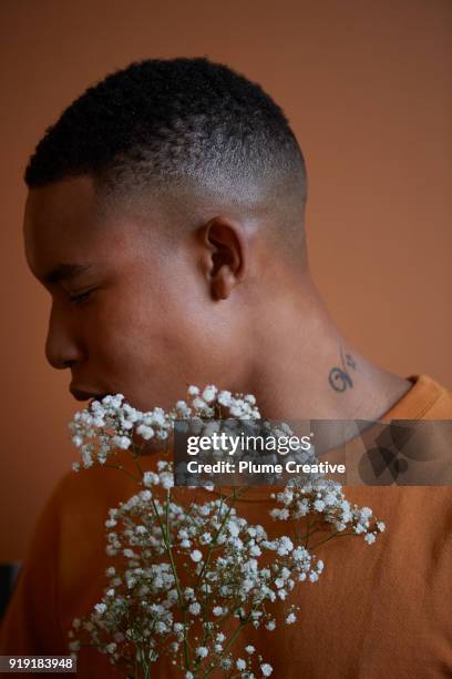 Profile of young man holding flowers