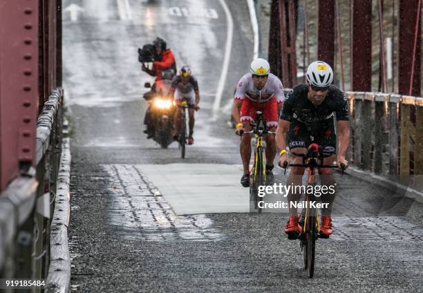 Dylan McNeice of NZ leads Javier Gomez of Spain and Branden Currie of NZ during the bike leg of the 2018 Challenge Wanaka on February 17, 2018 in...