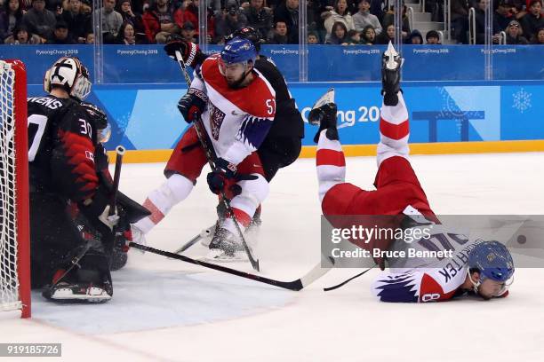 Tomas Kundratek of the Czech Republic collides with Mat Robinson of Canada in the second period during the Men's Ice Hockey Preliminary Round Group A...