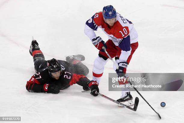 Cody Goloubef of Canada fights for the puck with Roman Cervenka of the Czech Republic during the Men's Ice Hockey Preliminary Round Group A game on...