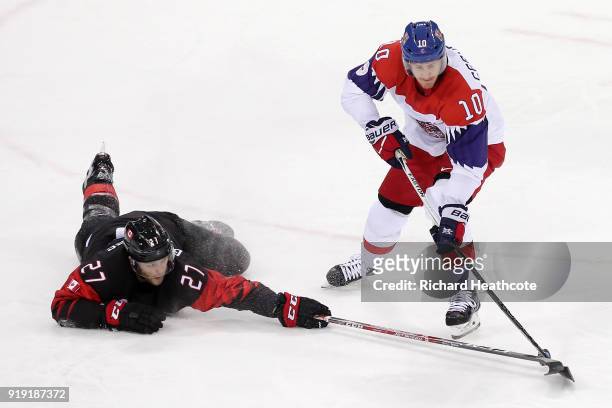 Cody Goloubef of Canada fights for the puck with Roman Cervenka of the Czech Republic during the Men's Ice Hockey Preliminary Round Group A game on...