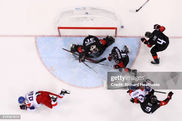 Tomas Kundratek of the Czech Republic collides with Mat Robinson of Canada in the second period during the Men's Ice Hockey Preliminary Round Group A...