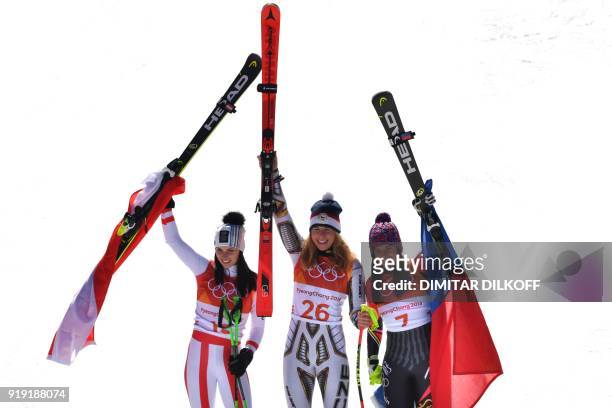Winner Czech Republic's Ester Ledecka celebrates on the podium next to Liechtenstein's Tina Weirather , third placed, and Austria's Anna Fenninger...
