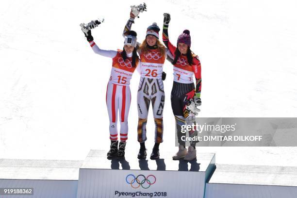 Winner Czech Republic's Ester Ledecka celebrates on the podium next to Liechtenstein's Tina Weirather , third placed, and Austria's Anna Fenninger...