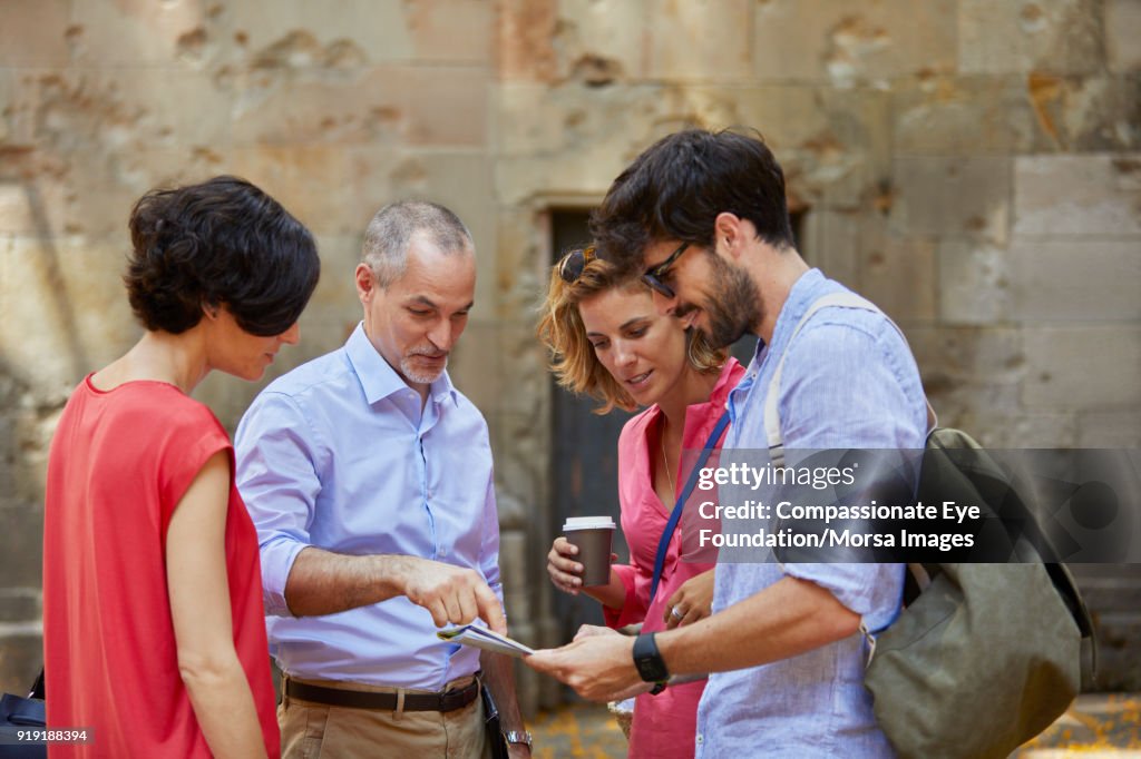 Tourists looking at map on street in Barcelona
