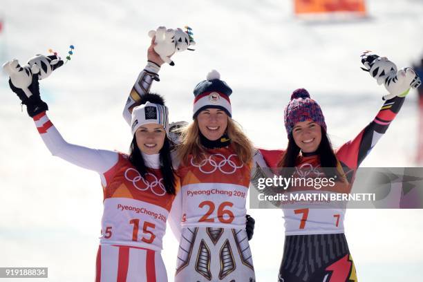 Winner Czech Republic's Ester Ledecka celebrates on the podium next to Liechtenstein's Tina Weirather , third placed, and Austria's Anna Fenninger...