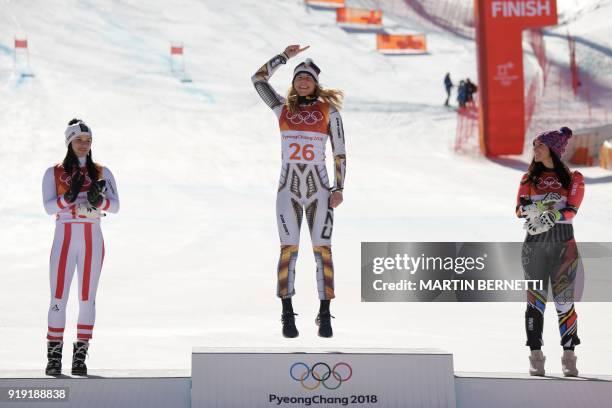 Winner Czech Republic's Ester Ledecka celebrates on the podium next to Liechtenstein's Tina Weirather , third placed, and Austria's Anna Fenninger...