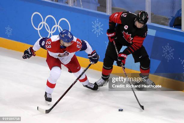 Rob Klinkhammer of Canada controls the puck against Ondrej Nemec of the Czech Republic in the third period during the Men's Ice Hockey Preliminary...