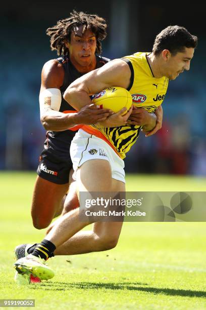 Jason Castagna of the Tigers is tackled Aiden Bonar of the Giants during the AFLX match between GWS Giants and the Richmond Tigers at Allianz Stadium...