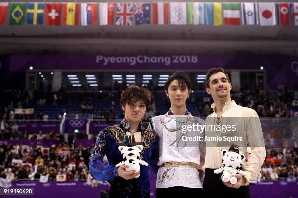 Silver medal winner Shoma Uno of Japan, gold medal winner Yuzuru Hanyu of Japan and bronze medal winner Javier Fernandez of Spain celebrate during...