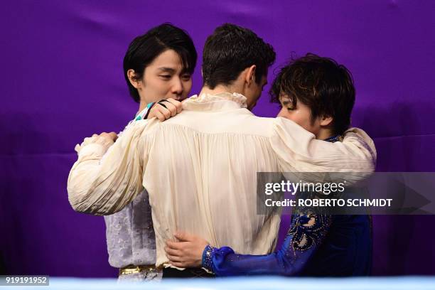 Winner Japan's Yuzuru Hanyu talks with third-placed Spain's Javier Fernandez and second-placed Japan's Shoma Uno during the venue ceremony after the...