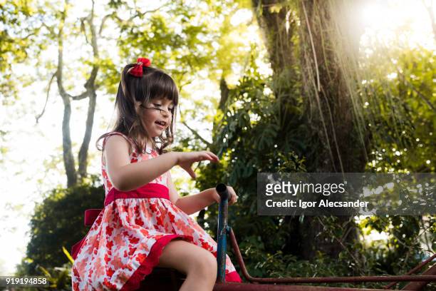 cute little girl outdoor - moving down to seated position stock pictures, royalty-free photos & images