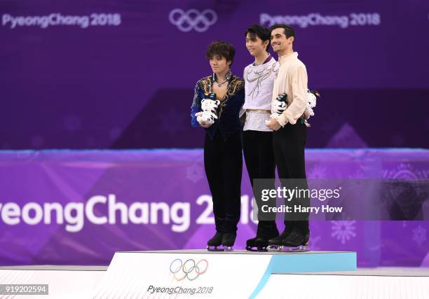 Silver medal winner Shoma Uno of Japan, gold medal winner Yuzuru Hanyu of Japan and bronze medal winner Javier Fernandez of Spain celebrate during...