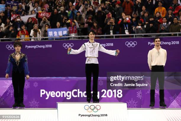 Silver medal winner Shoma Uno of Japan, gold medal winner Yuzuru Hanyu of Japan and bronze medal winner Javier Fernandez of Spain celebrate during...