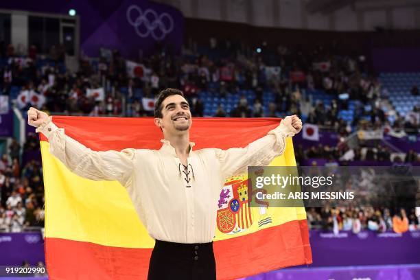 Bronze medallist Spain's Javier Fernandez poses with his national flag during the venue ceremony after the men's single skating free skating of the...