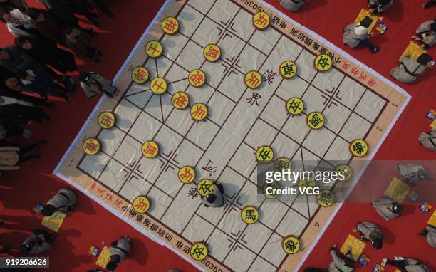 Aerial view of children in Han costumes playing chess to entertain the spectators at a temple on the first day of Spring Festival on February 16,...