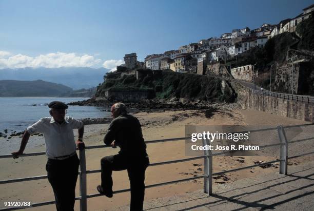 Lastres beach, Asturias Two aged men watch the Lastres beach, Asturias